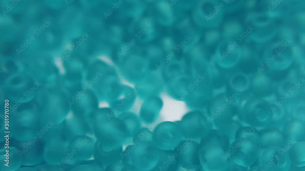 Pouring mint beads into a bag before making jewelry. Pouring mint beads into a bag before making jewelry.