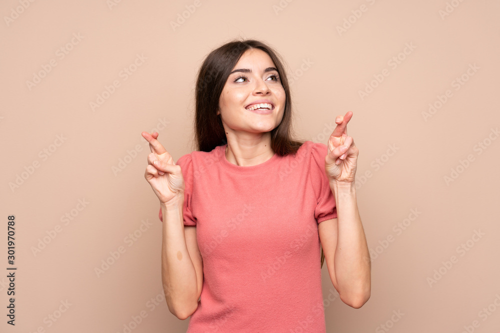 Young woman over isolated background with fingers crossing Young woman over isolated background with fingers crossing