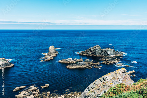 cliffs by the atlantic ocean on sunny day photo