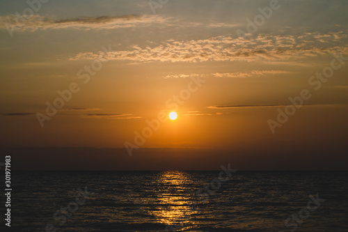 The bright orange sun in the sky