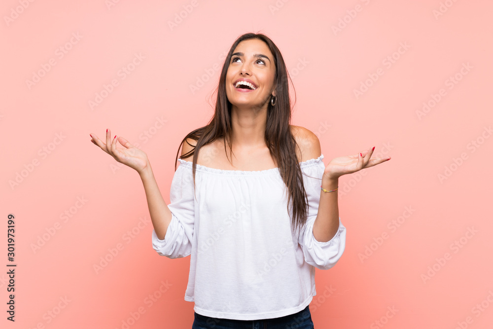 Young woman over isolated pink background smiling a lot