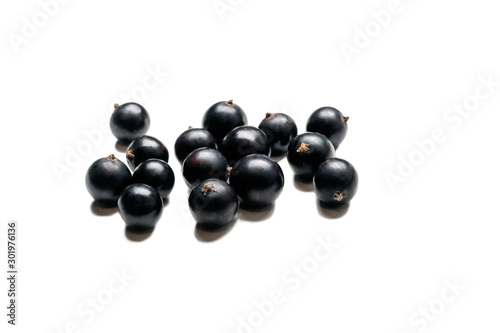 Blackcurrant isolated on white background. Currant macro photo. Heap of black currant berry.