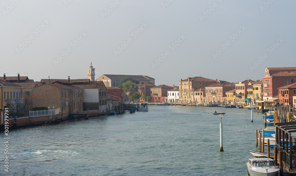 Old buildings in Murano island. Canal view with boats. Travel photo. Italy. Europe.