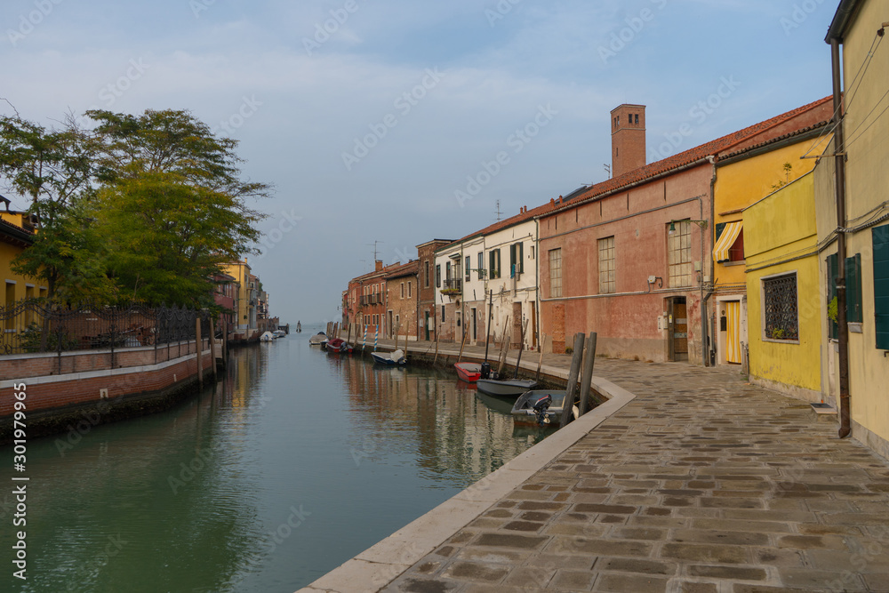 Old buildings in Murano island. Canal view with boats. Travel photo. Italy. Europe.