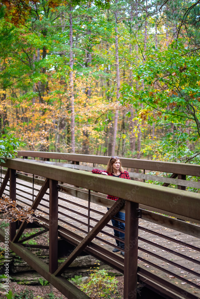 woman standing on bridge in Autumn