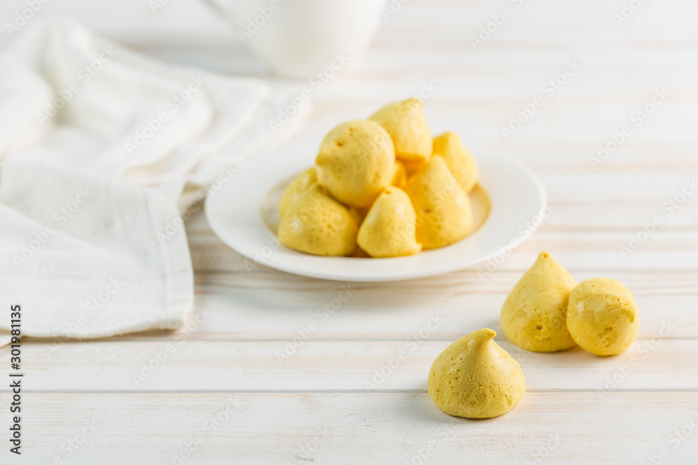 Banana meringue in a white plate and a Cup of tea on a light background. Sugar-free