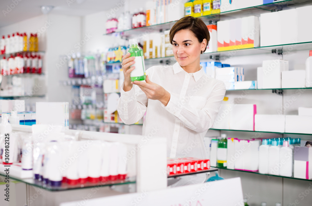 Young woman is browsing rows of body care products