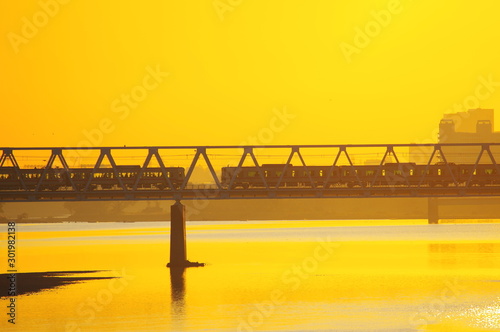 多摩川原橋から望む朝焼けと京王線多摩川橋梁 photo