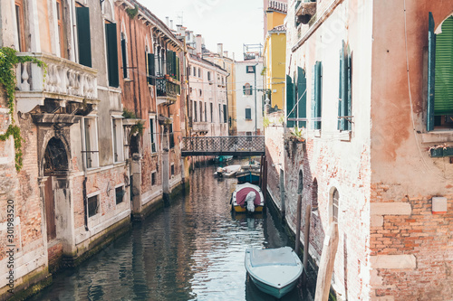 Green canal waters of Venice with boats. Quiet streets of Venice © alexngm