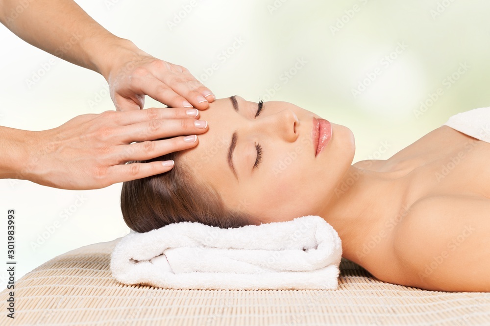 Beautiful young woman relaxing with  massage at beauty spa