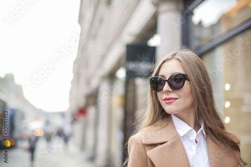 Beautiful woman walking in the street and smiling