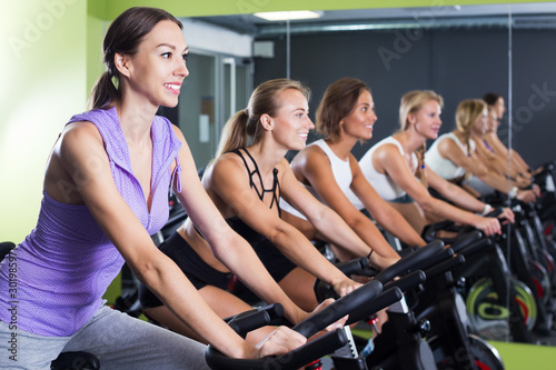 Women cycling in fitness center