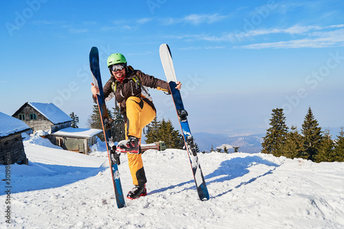 Funny skier mimics putting his skis on wrong, vertically. Location: Poiana Brasov ski resort, Romania.
