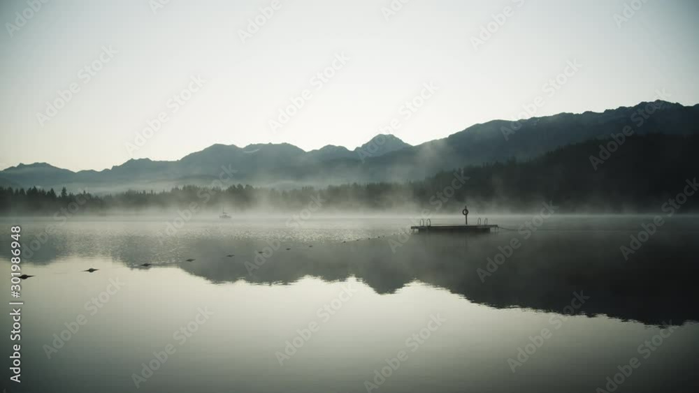 Wooden Floater Deck in the Middle of a Foggy Rainbow Lake 