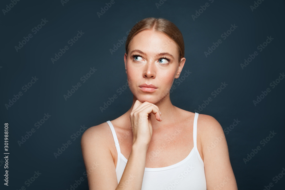 Beautiful woman looking aside on blue background