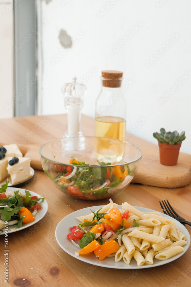 pasta with vegetable salad and cheesecake with berries lunch concept in a cafe. vegetarianism. vegan food pasta with vegetable salad and cheesecake with berries lunch concept in a cafe. vegetarianism. vegan food