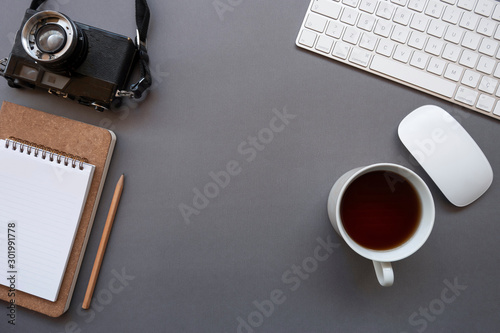 Work office desk with keyboard  mouse  coffee  notepad  pencil  glasses and photo camera
