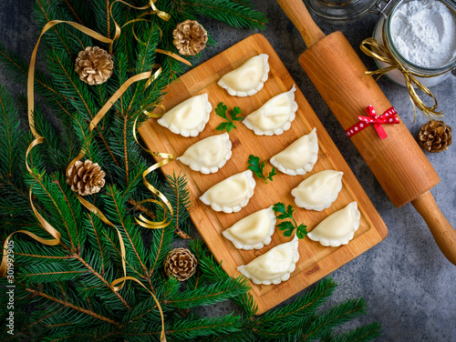 Christmas dumplings with decoration on a wooden board. Top view.