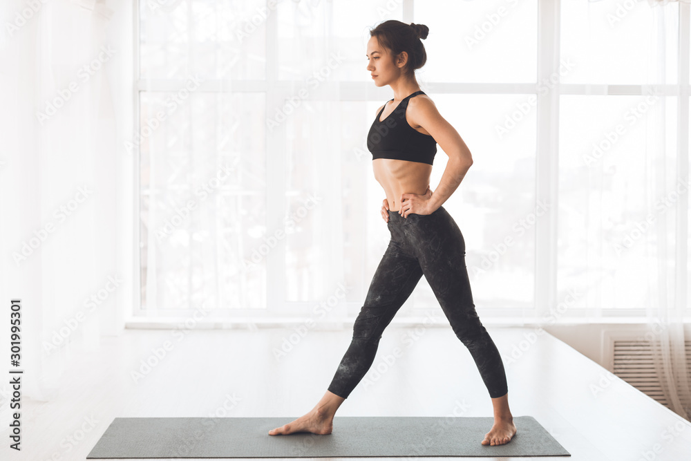 Fototapeta premium Yoga training. Slim preparing for doing stretching exercise