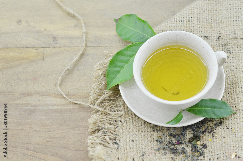 Fresh cup of tea on wooden table Fresh cup of tea on wooden table