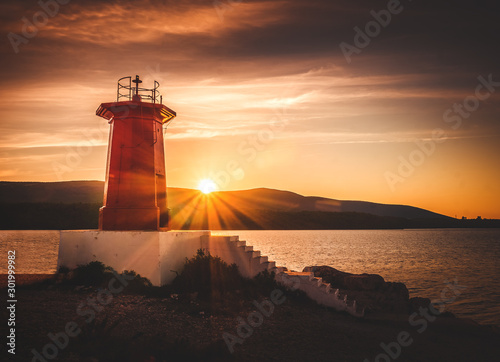 Sun rising at red lighthouse