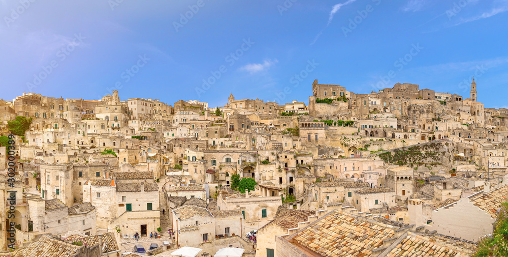 Aerial panoramic view of historical centre Sasso Caveoso of old ancient town Sassi di Matera with rock cave houses, European Capital of Culture, UNESCO World Heritage Site, Basilicata, Southern Italy