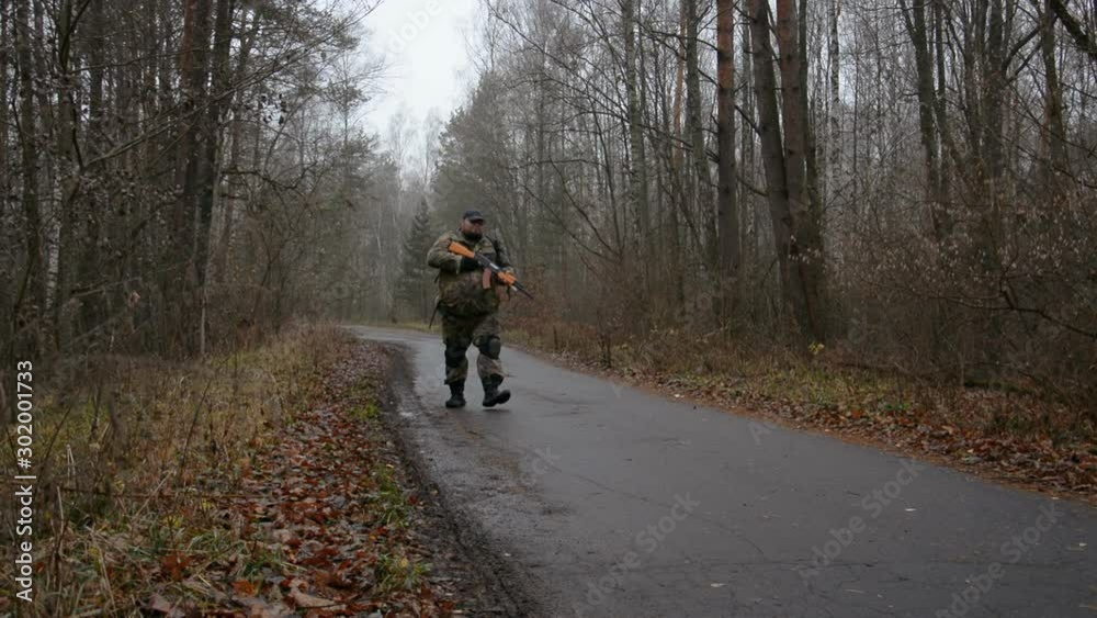 Soldier walking through autumn forest Soldier walking through autumn forest