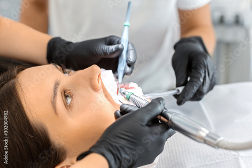Close up of woman having treatment at dentist doctor