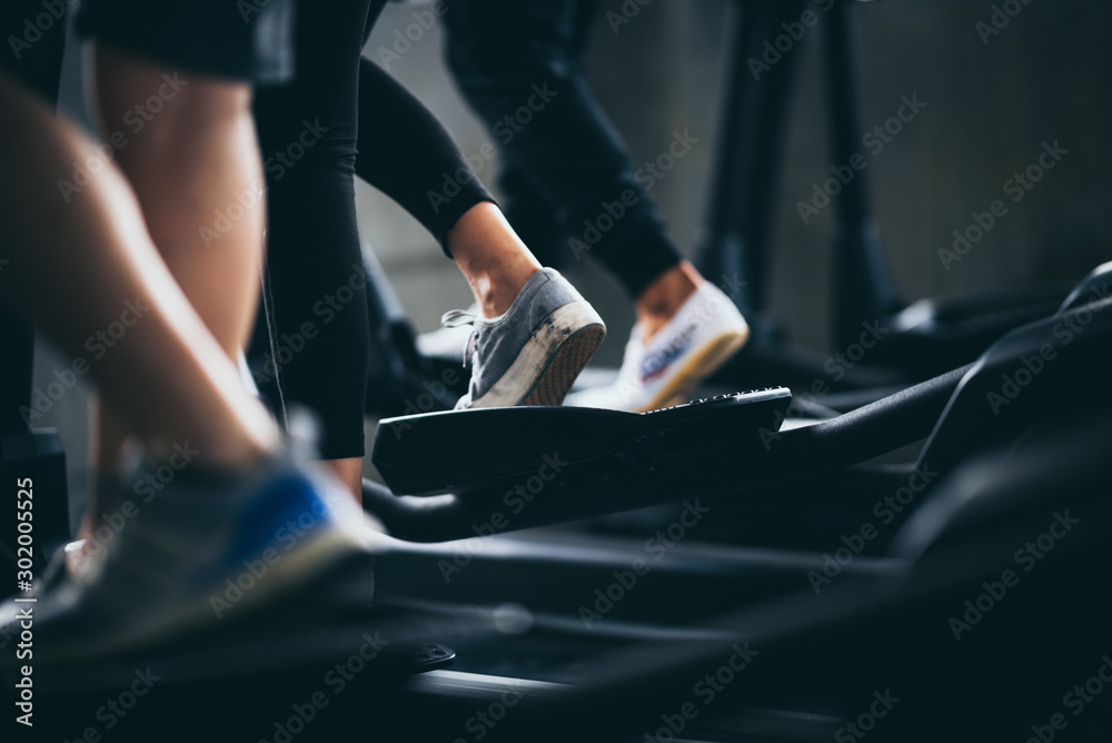 People running in machine treadmill at fitness gym club People running in machine treadmill at fitness gym club