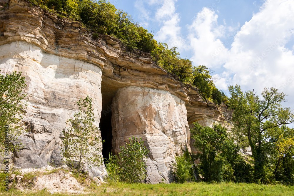 landscape of cliffs with a cave entrance