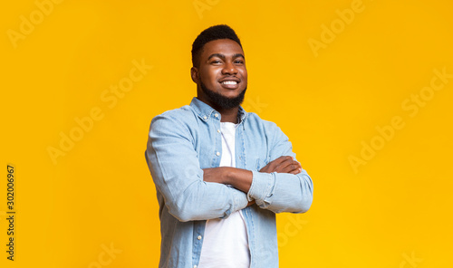 Confident african american guy standing with his arms crossed photo