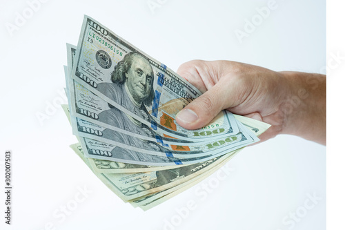 Hand holding US dollar banknote on white background. USD banknote is main and popular currency of exchange in the world.Investment and saving concept.