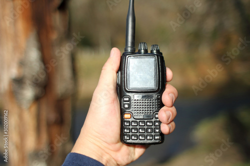 A modern dual band walkie talkie radio with keyboard.