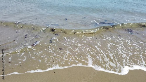 San Francisco, USA - August 2019: Close up of waves in slow motion, washing over the beach on a summer day