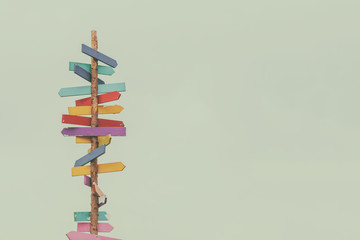 Retro styled image of colorful wooden direction arrow signs