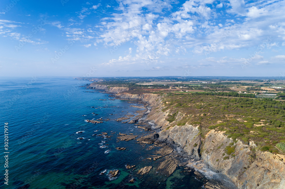 Fototapeta premium Aerial view of the coastline and cliffs near the Esteveira Beach in Aljezur, Algarve.