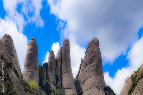 Rocky climbing tops above Santa Maria de Montserrat abbey in Monistrol, Catalonia, Spain photo