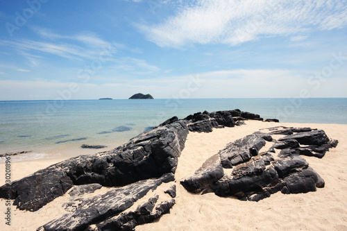 Beautiful seascape of the rocky beach and sea wave on seaside with blue sky at Samila beach in Thailand