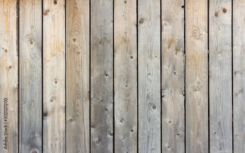 Wooden background, rustic fence, texture of natural wood darkened by time.