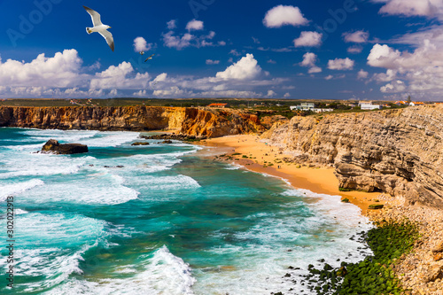 Panorama view of Praia do Tonel (Tonel beach) in Cape Sagres, Algarve, Portugal. Seagulls flying over Praia Do Tonel, beach located in Alentejo, Portugal. Ocean waves on Praia Do Tonel beach.