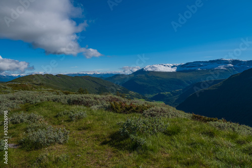 Through the Vikafjell a pass road to Vik is located in the kommunes Hordaland and Sogne og Fjordane. Mountains with summer snow on background. July 2019 © Сергій Вовк