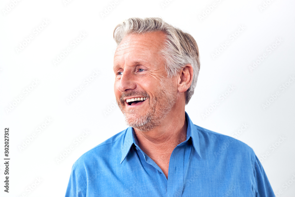 Studio Shot Of Mature Man Against White Background Laughing At Camera Studio Shot Of Mature Man Against White Background Laughing At Camera