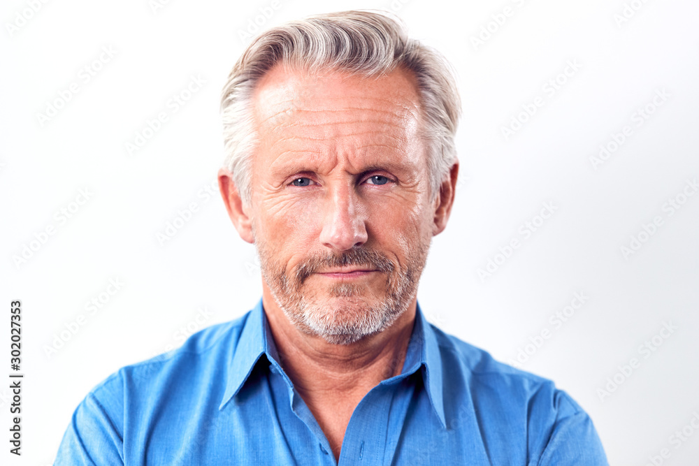 Studio Shot Of Mature Man With Serious Expression Against White Background At Camera Studio Shot Of Mature Man With Serious Expression Against White Background At Camera