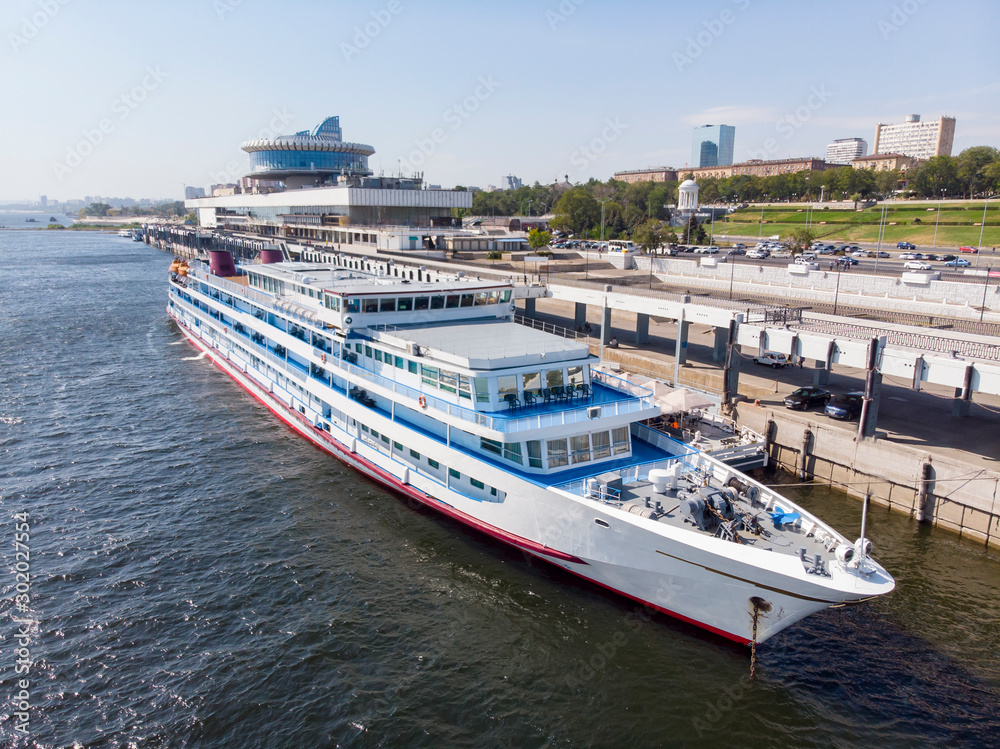 A cruise ship with tourists on the Volga stands at the pier on the central promenade of the city of Volgograd. Russia