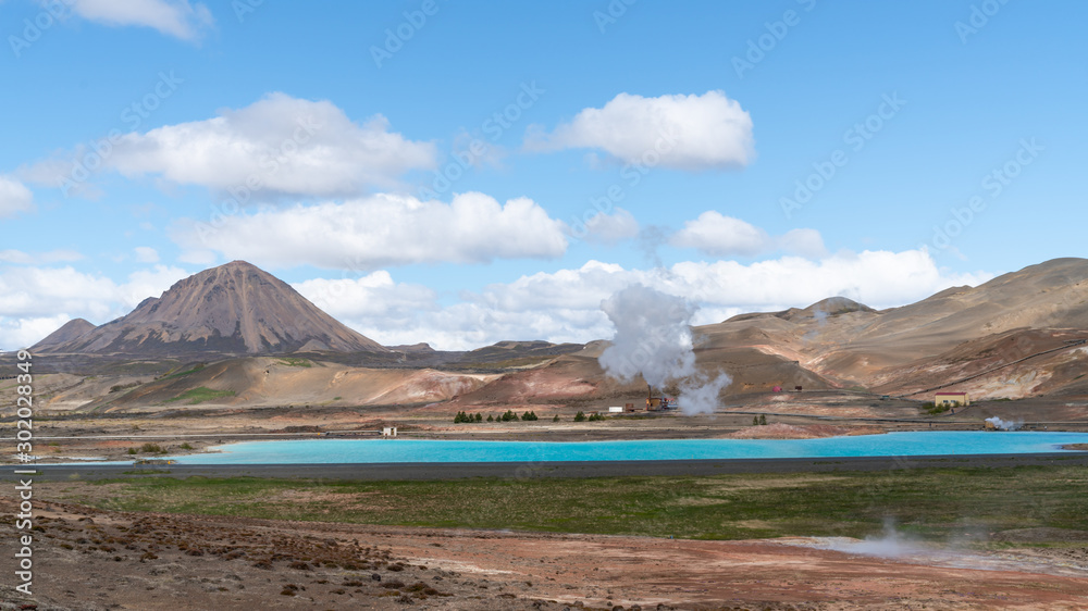 Blue lake in Hverir Myvatn geothermal area with boiling mudpools and steaming fumaroles, Iceland Blue lake in Hverir Myvatn geothermal area with boiling mudpools and steaming fumaroles, Iceland