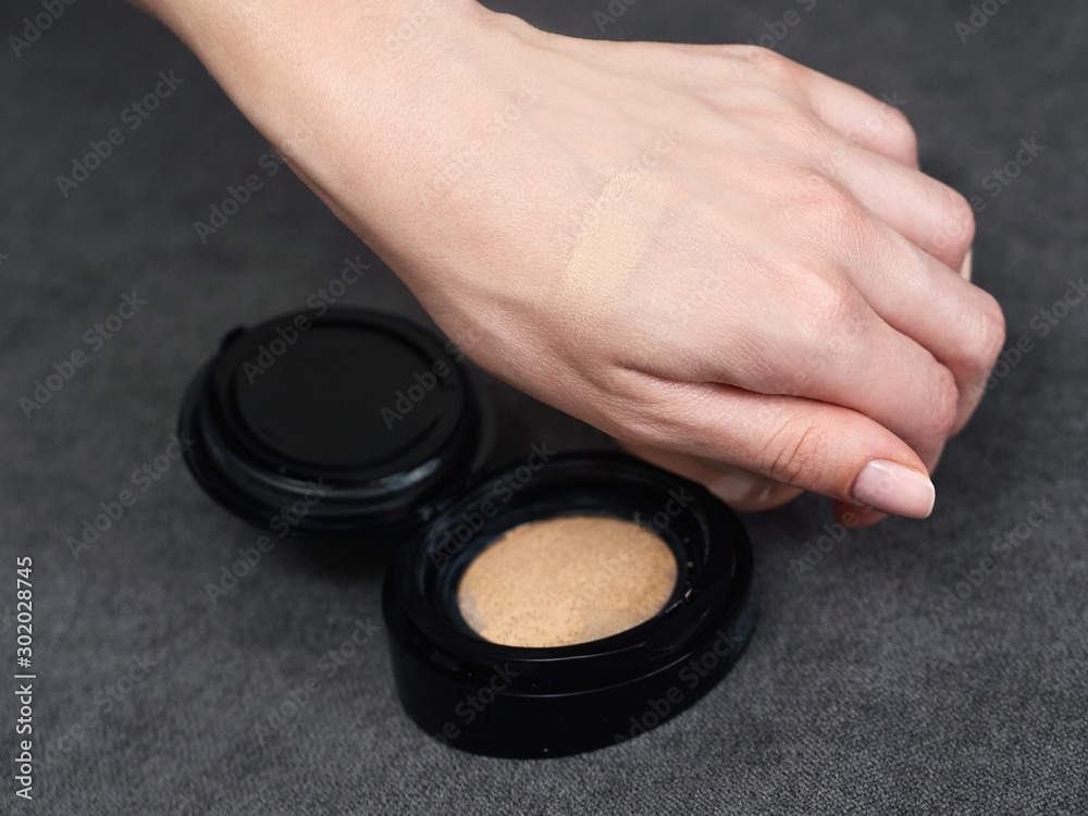 Woman's beauty blogger hands holding bottles and tubes spa professional ...