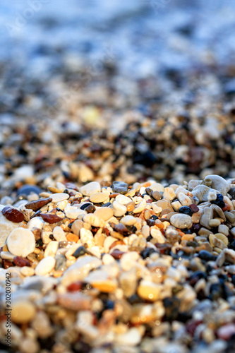 Beach pebbles backlit by a bright sunbeam.