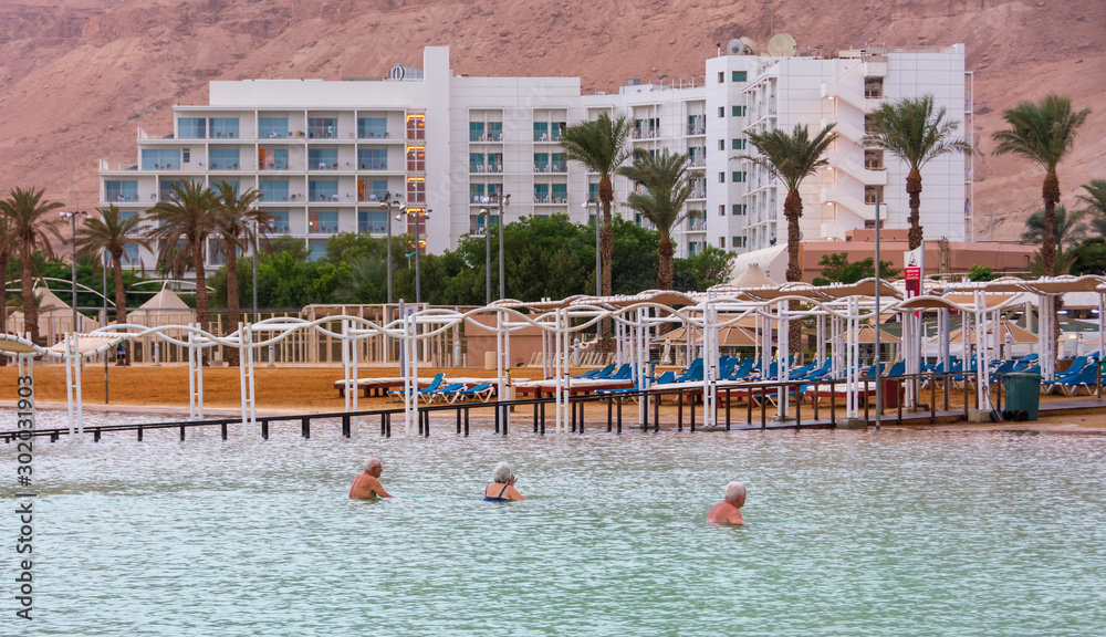 People enjoying the Dead Sea at golden hour