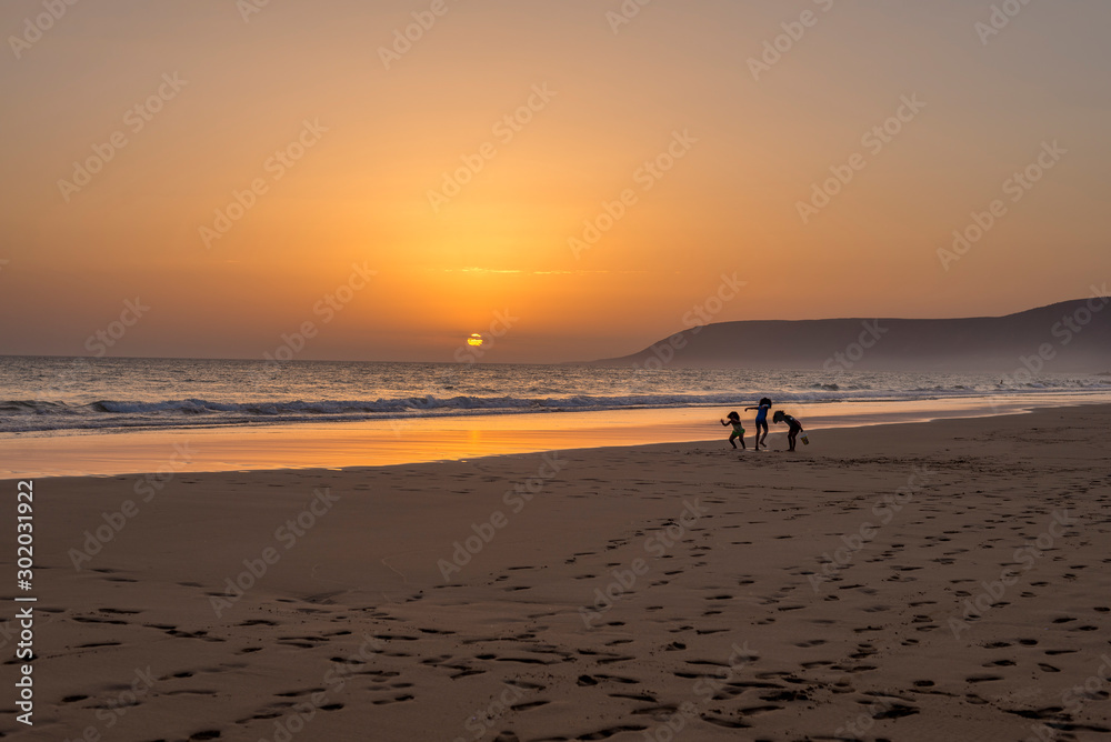 three girls playing at the beach