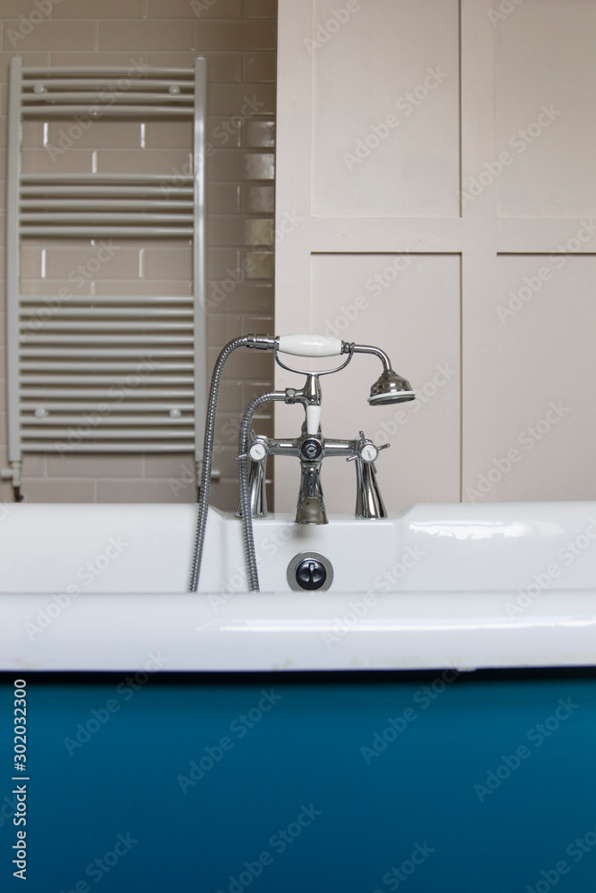 Luxury bathroom interior with classic rolltop bath tub and vintage tap Luxury bathroom interior with classic rolltop bath tub and vintage tap